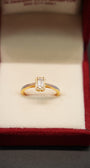 Gold ring with a diamond in a red jewelry box
