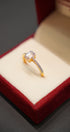 Gold ring with a diamond in a red jewelry box