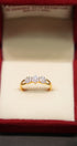 Gold ring with diamonds in a red box