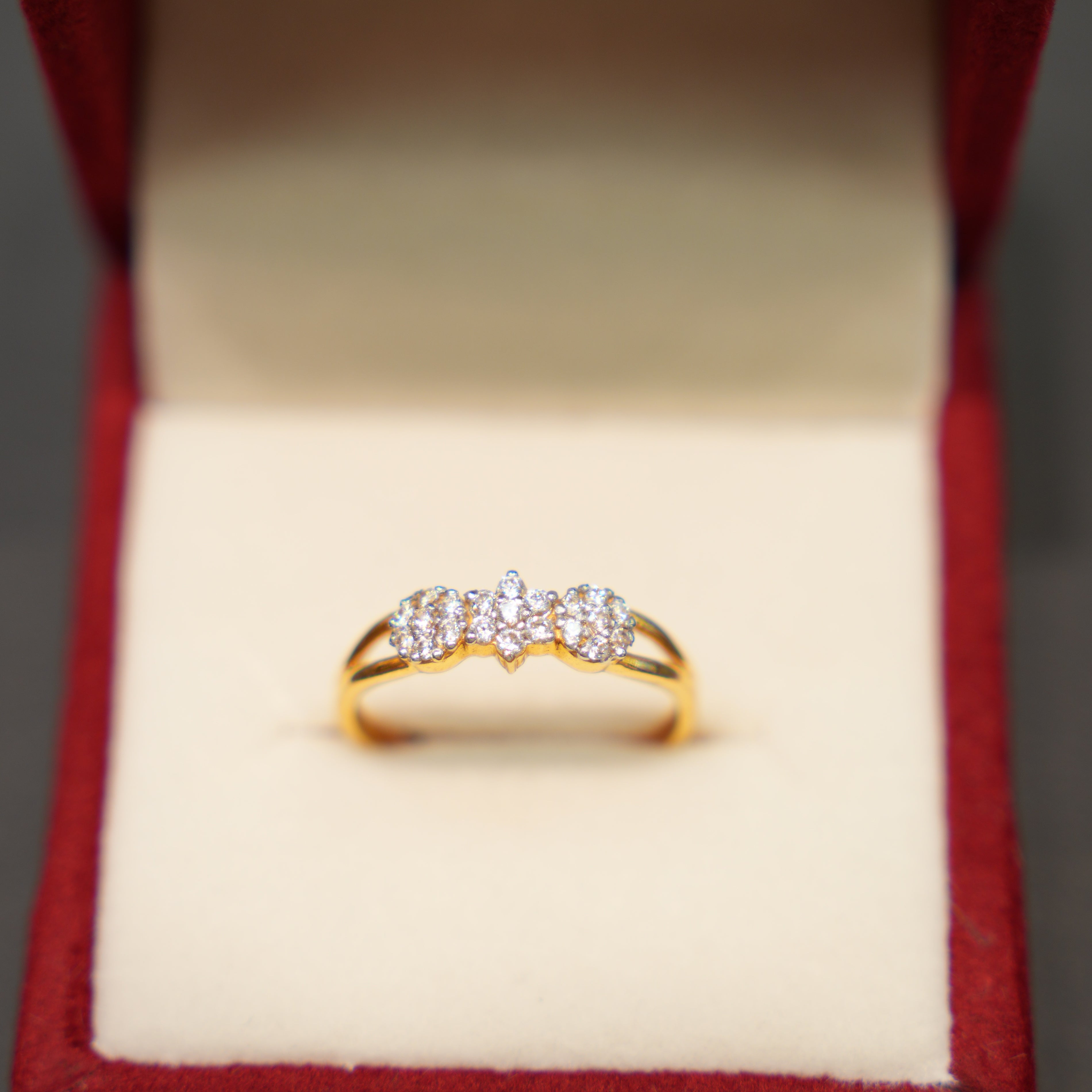 Gold ring with diamonds in a red box