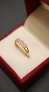 Gold ring with diamonds in a red velvet box