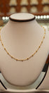 Gold necklace on a mannequin bust with a blurred background
