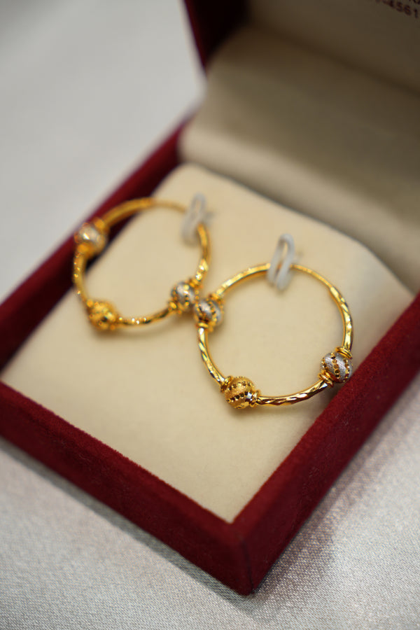 Gold hoop earrings in a jewelry box