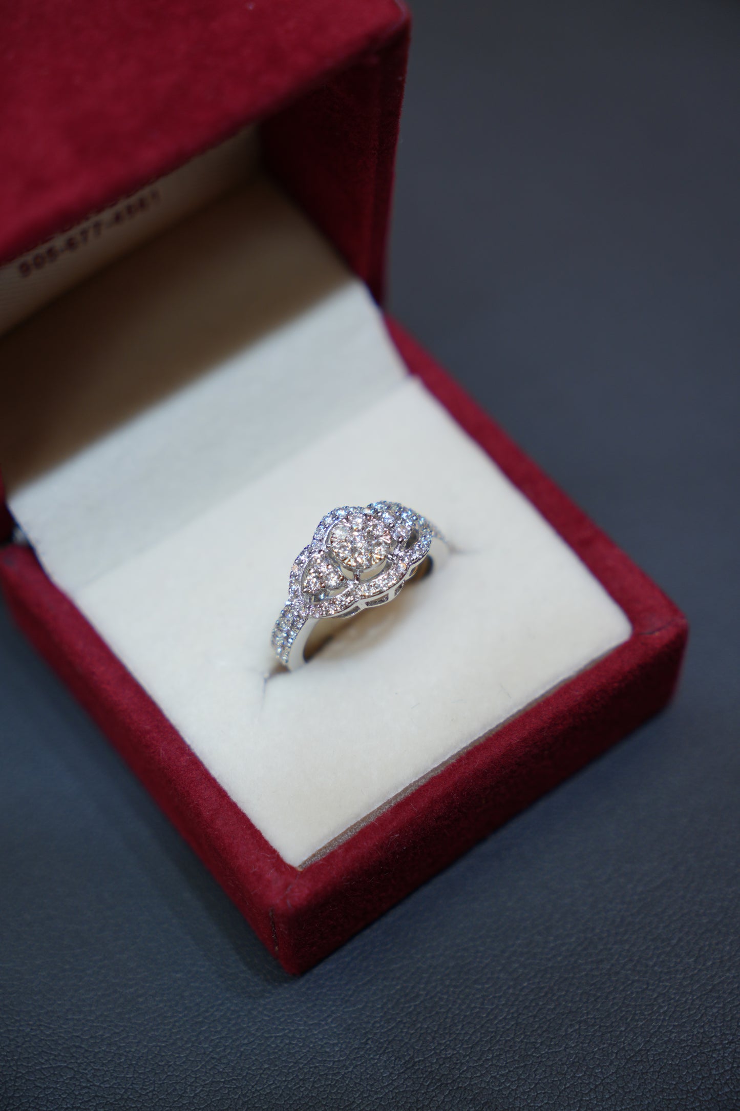 Exquisite diamond ring in 14K white gold displayed in a red velvet ring box. Diamond Rings at Punjab Jewellers.