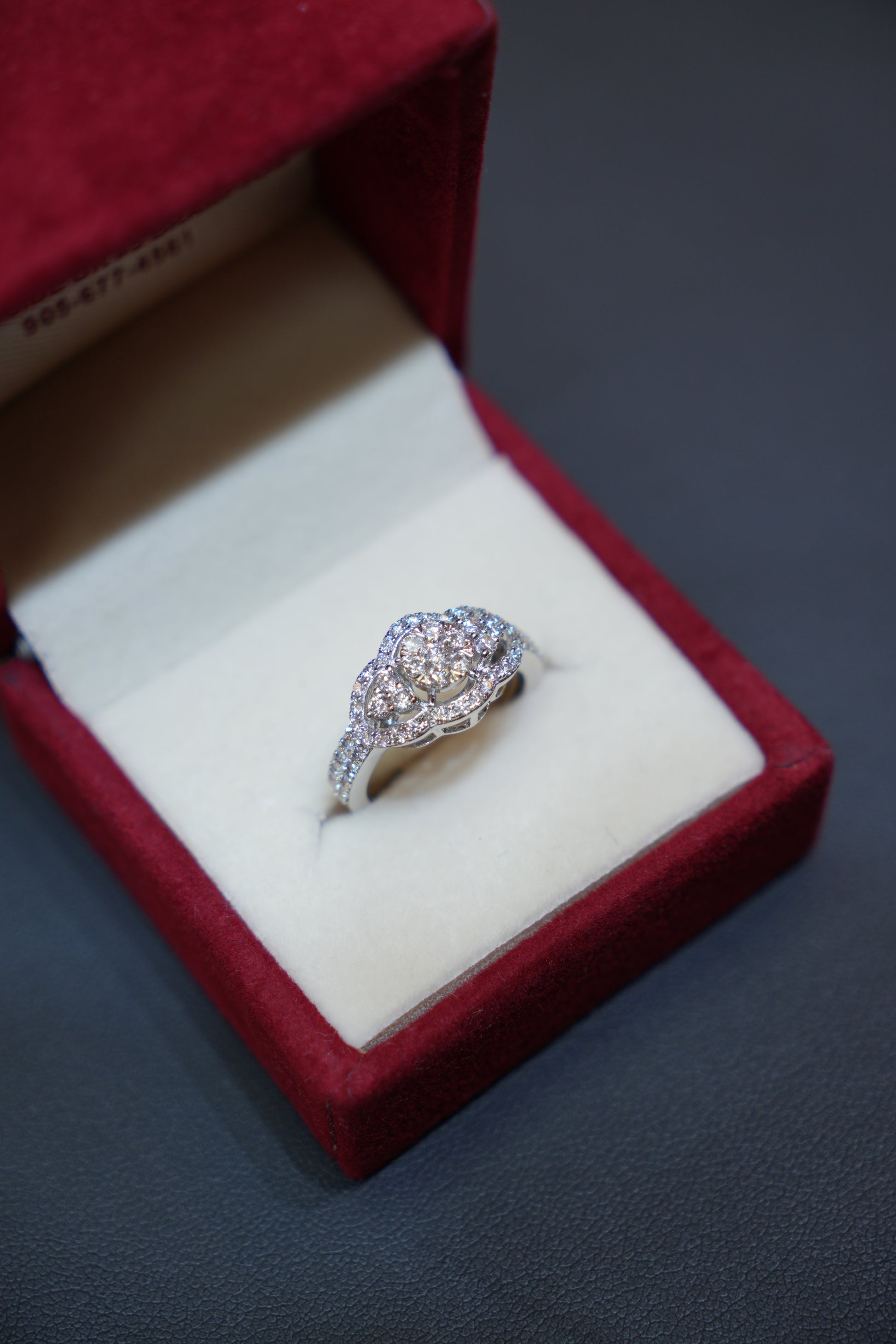 Exquisite diamond ring in 14K white gold displayed in a red velvet ring box. Diamond Rings at Punjab Jewellers.