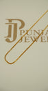 Gold chain on a beige background 
