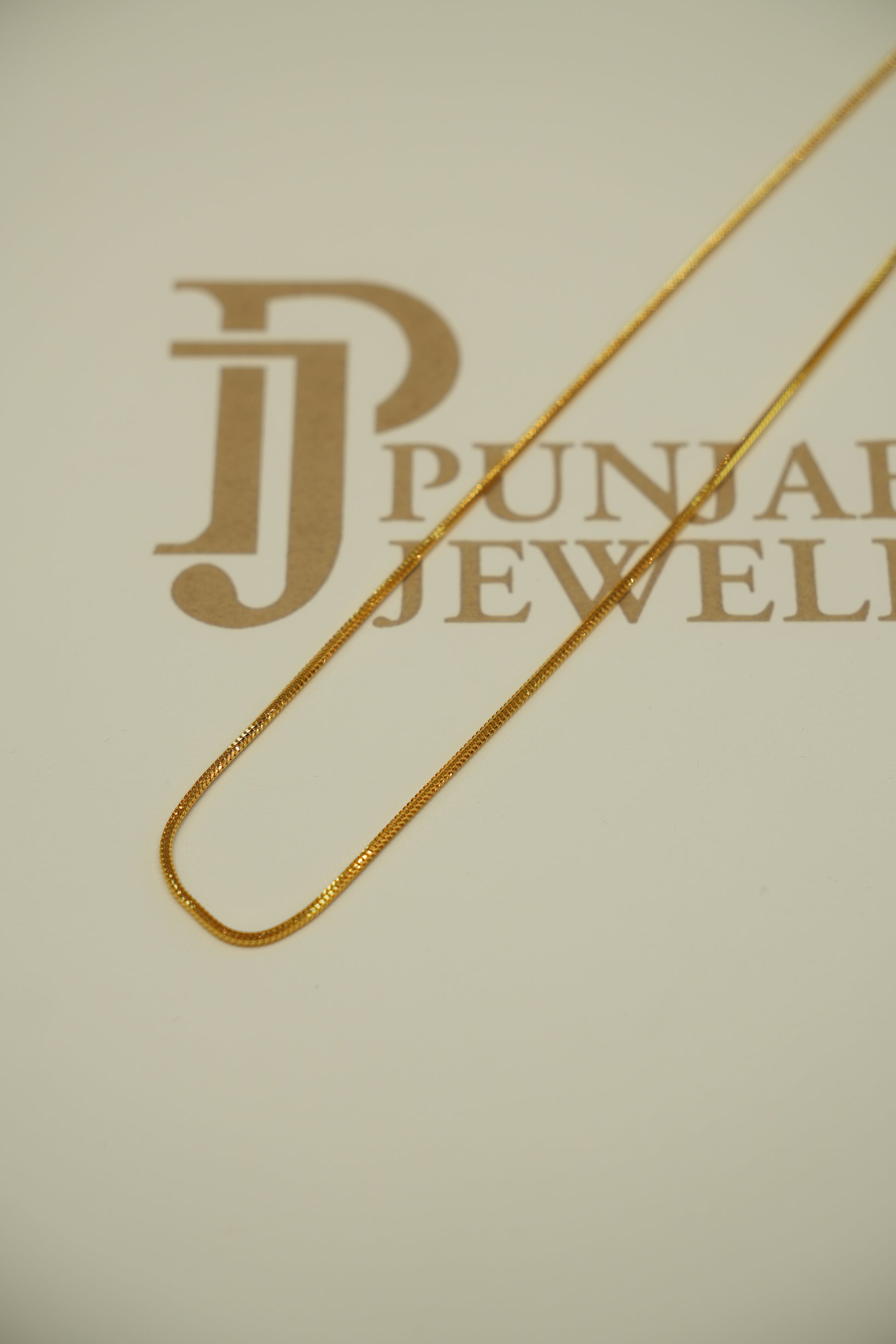 Gold chain on a beige background 
