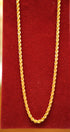 Gold chain on a red textured background