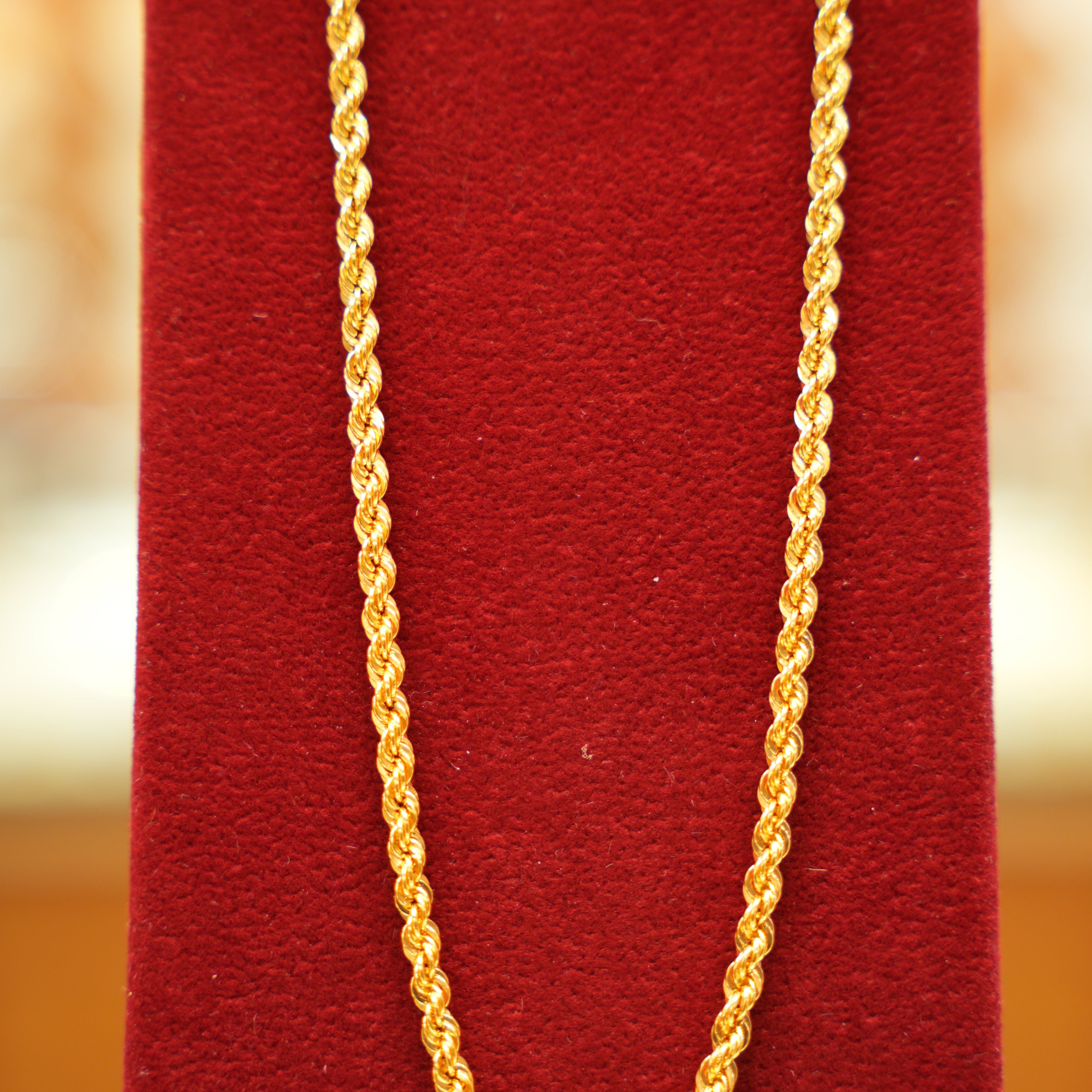 Gold chain on a red textured background