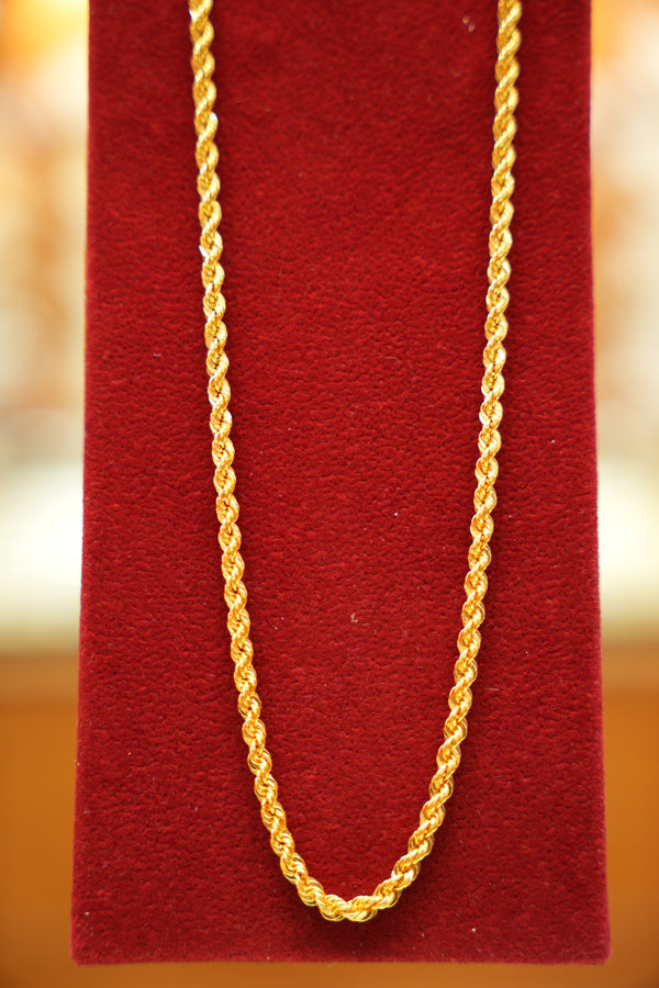 Gold chain on a red textured background