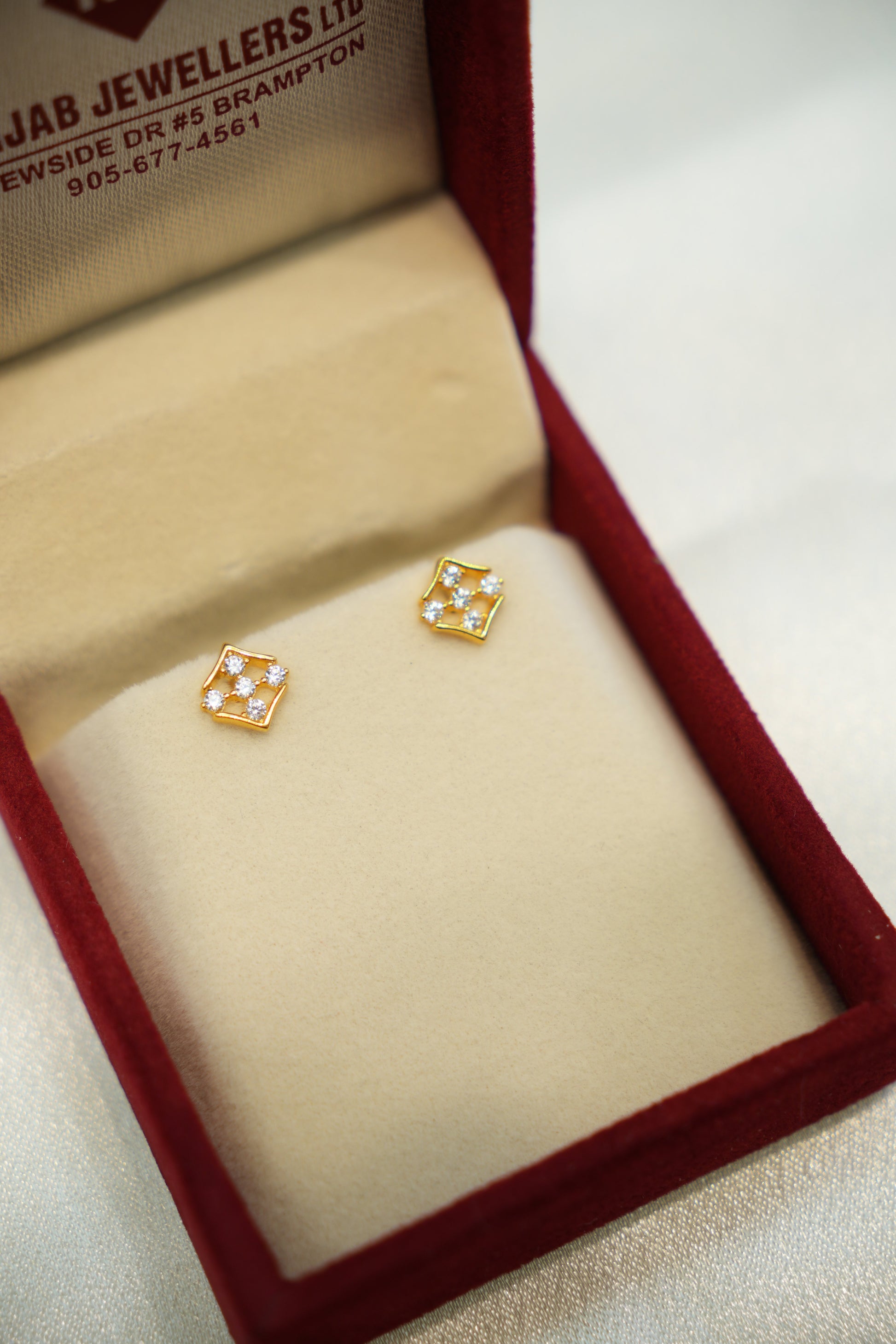 Gold earrings in a jewelry box 