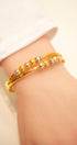 Decorative gold bracelet with unique link pattern