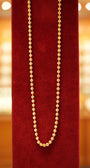 Beautiful gold chain on red velvet stand