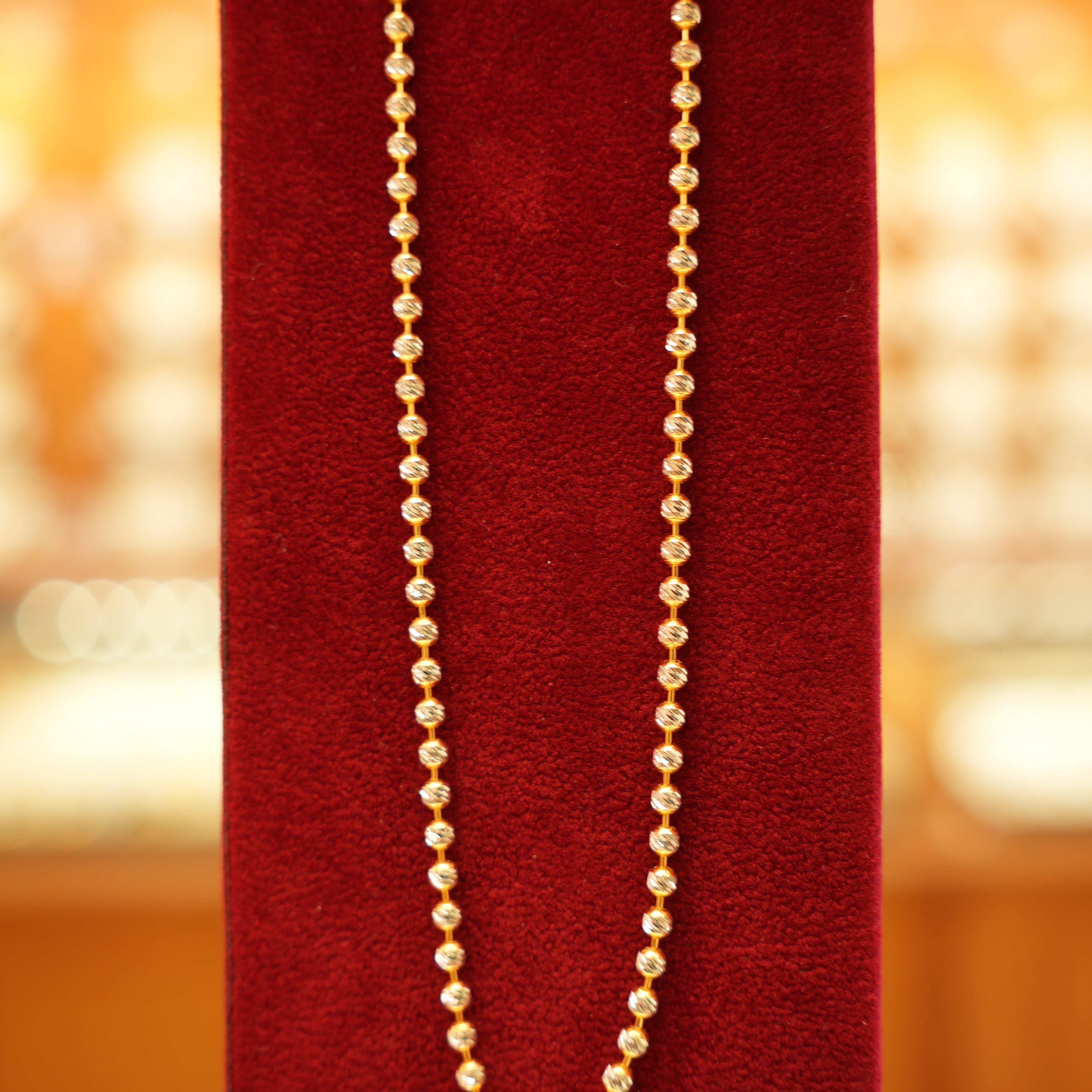 Beautiful gold chain on red velvet stand