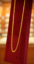 Gold chain on a red fabric with a blurred background