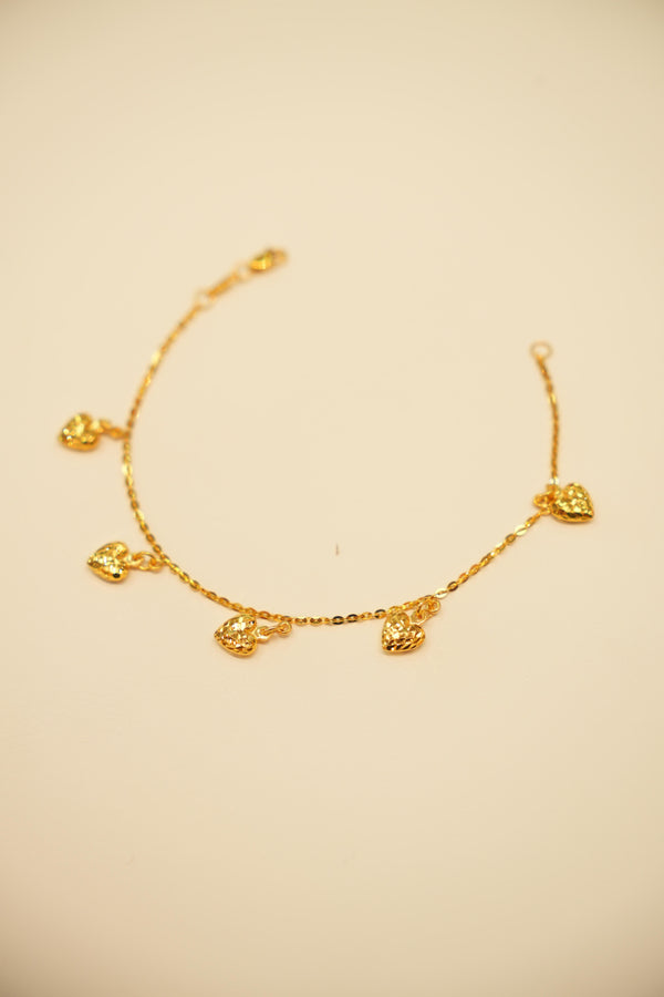 Gold bracelet with heart-shaped charms 