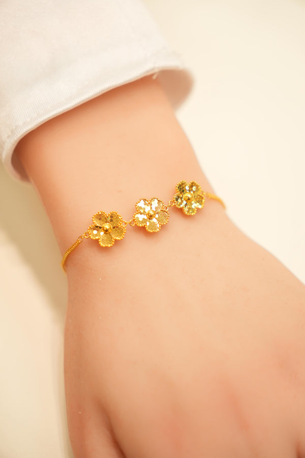 Gold floral bracelet with crystal accents