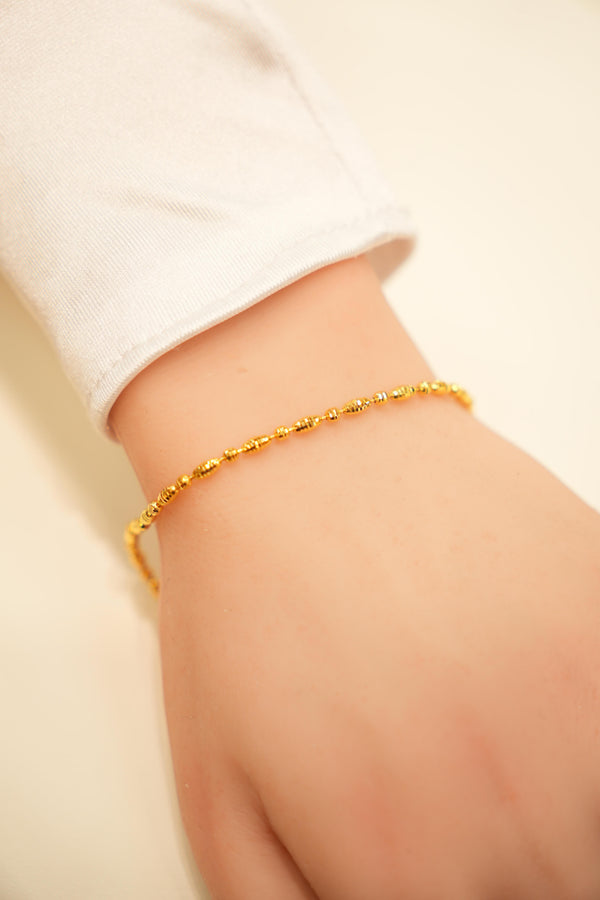 Gold chain bracelet with charms