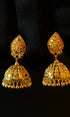 Pair of gold earrings on a black background