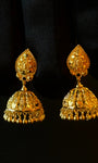 Pair of gold earrings on a black background