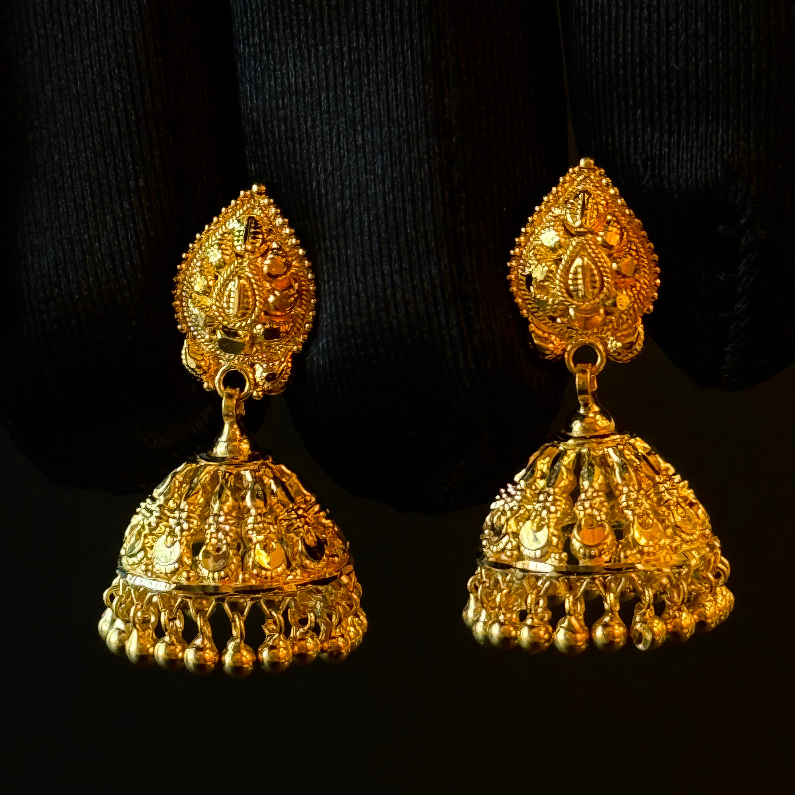Pair of gold earrings on a black background