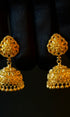 Pair of gold earrings on a black background
