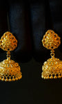 Pair of gold earrings on a black background