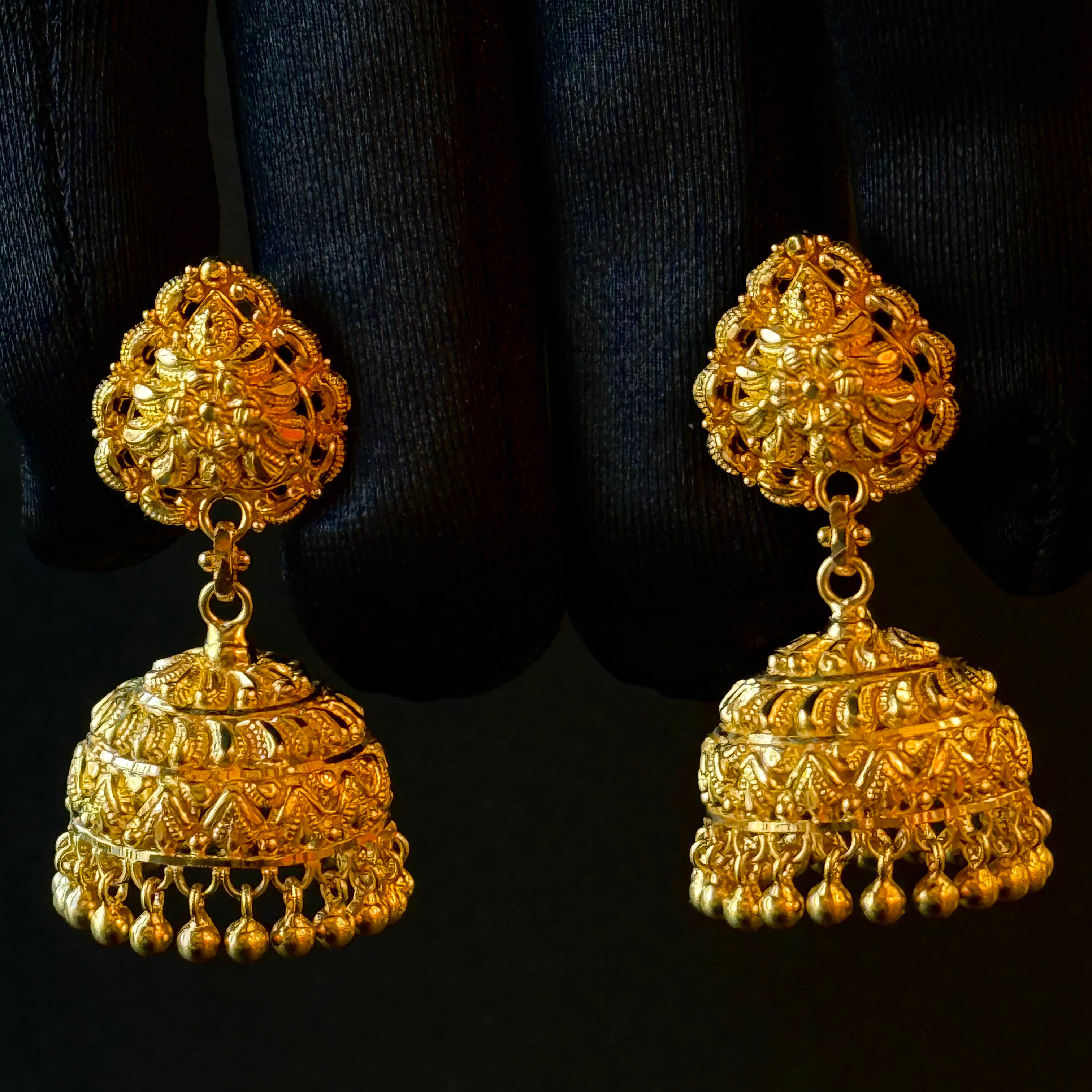 Pair of gold earrings on a black background
