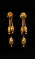 Pair of gold earrings on a black background