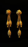 Pair of gold earrings on a black background