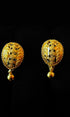 Pair of gold earrings on a black background
