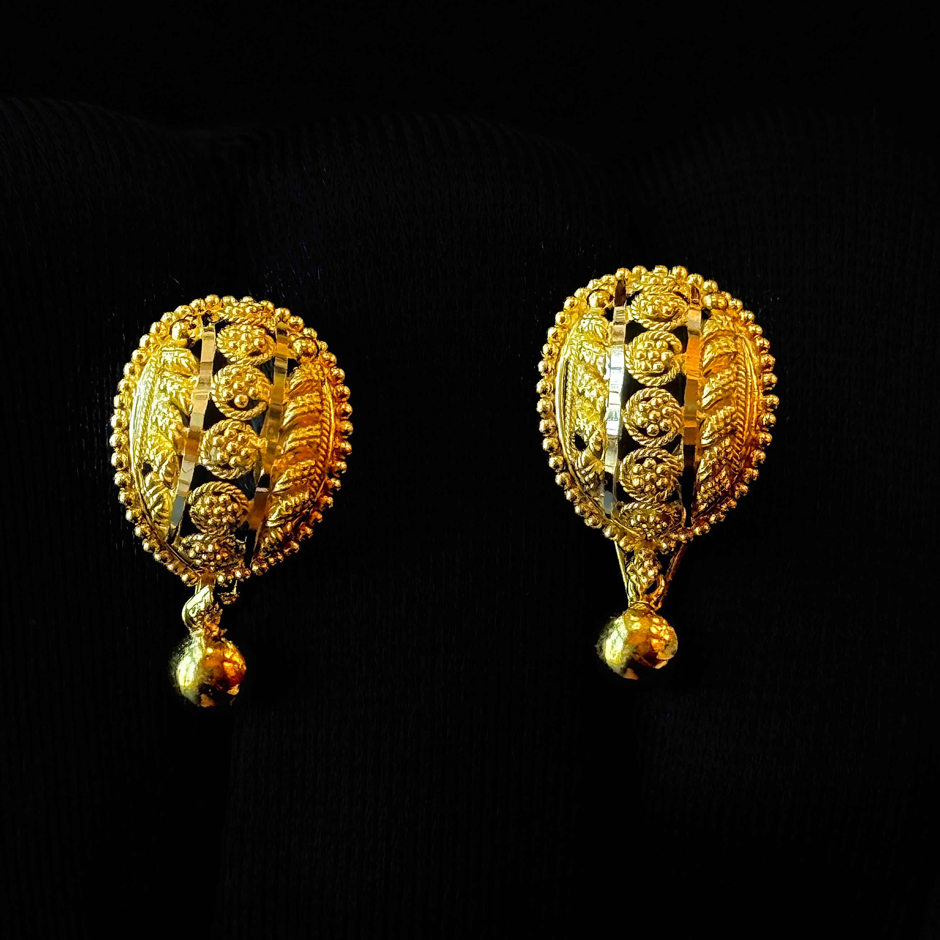 Pair of gold earrings on a black background