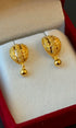 Gold earrings in a jewelry box
