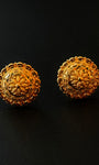 Pair of gold earrings on a black background
