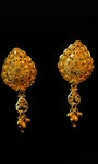 Pair of gold earrings on a black background