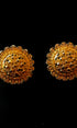 Pair of gold earrings on a black background