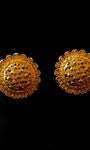 Pair of gold earrings on a black background