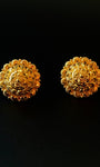 Pair of gold earrings on a black background