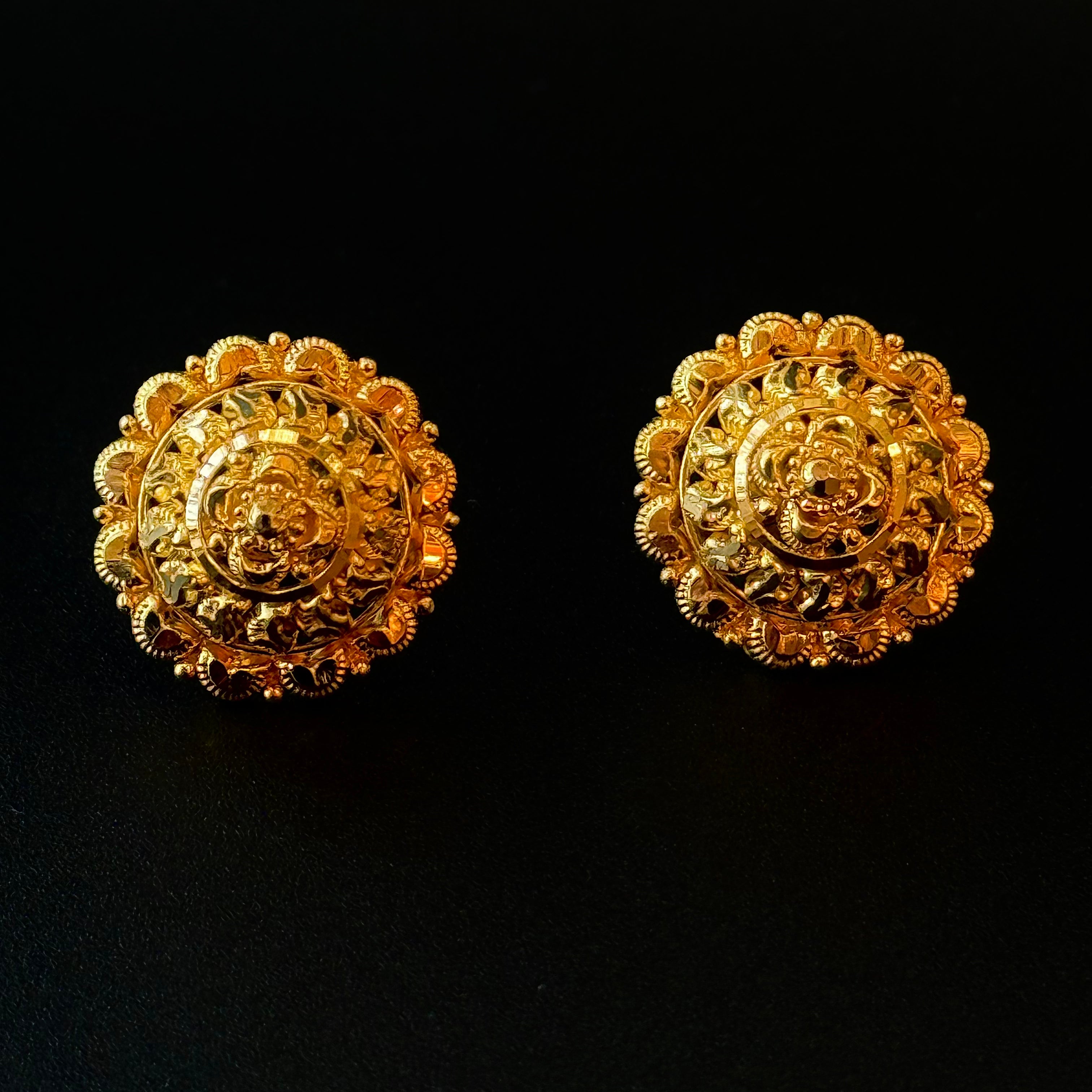 Pair of gold earrings on a black background