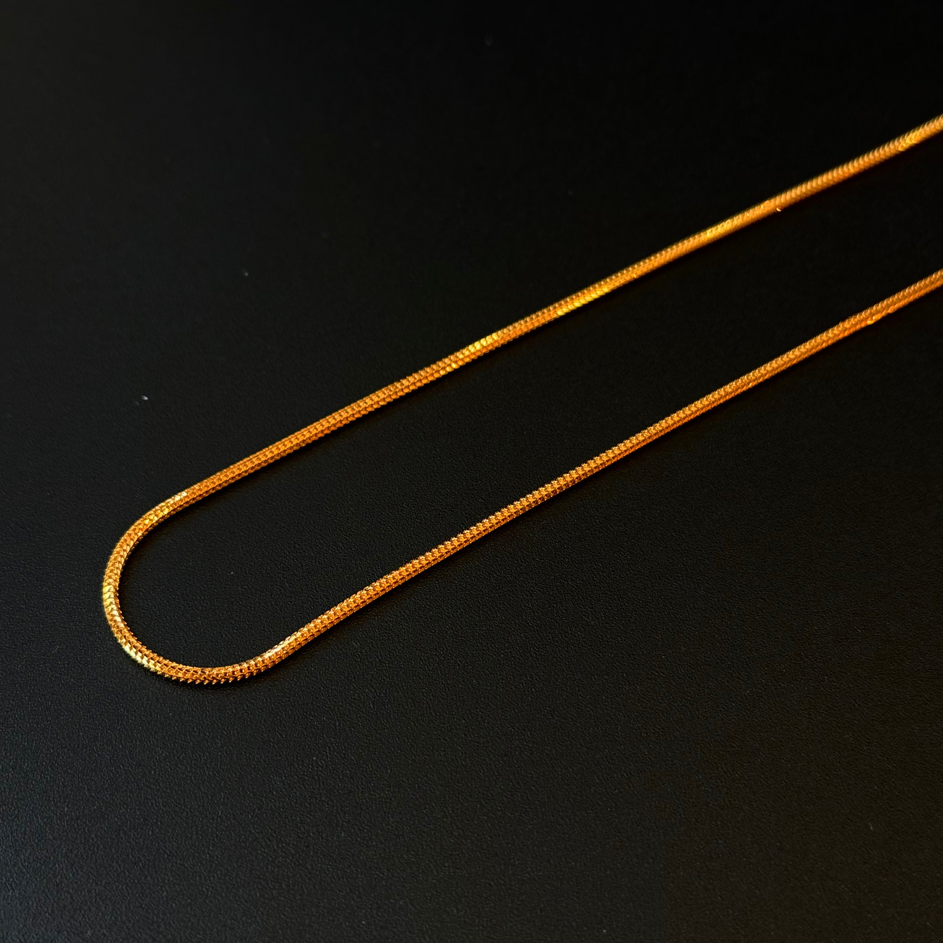 Gold chain on a black background
