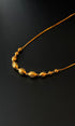 Gold necklace on a black background