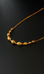 Gold necklace on a black background