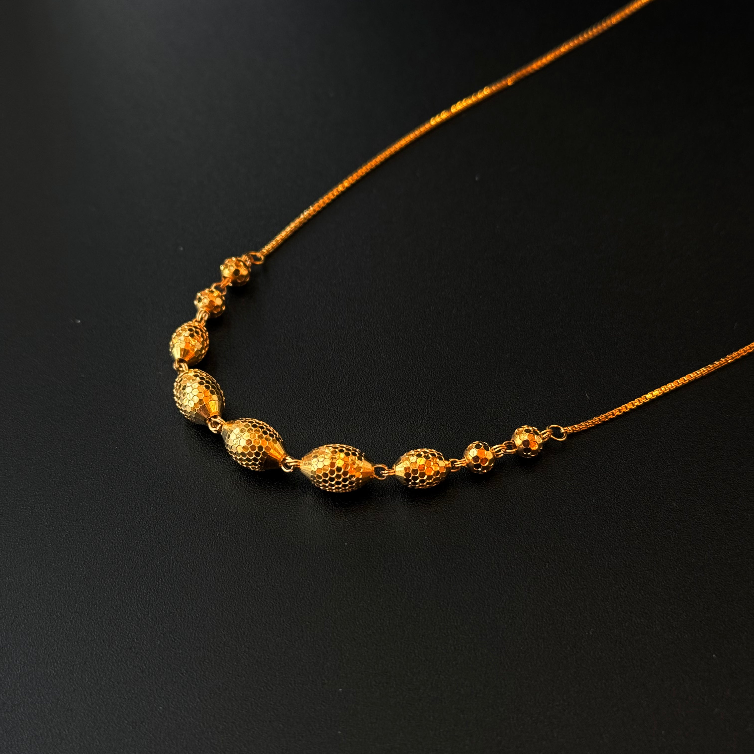 Gold necklace on a black background
