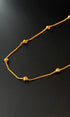 Gold necklace on a black background