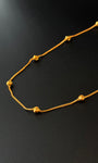 Gold necklace on a black background