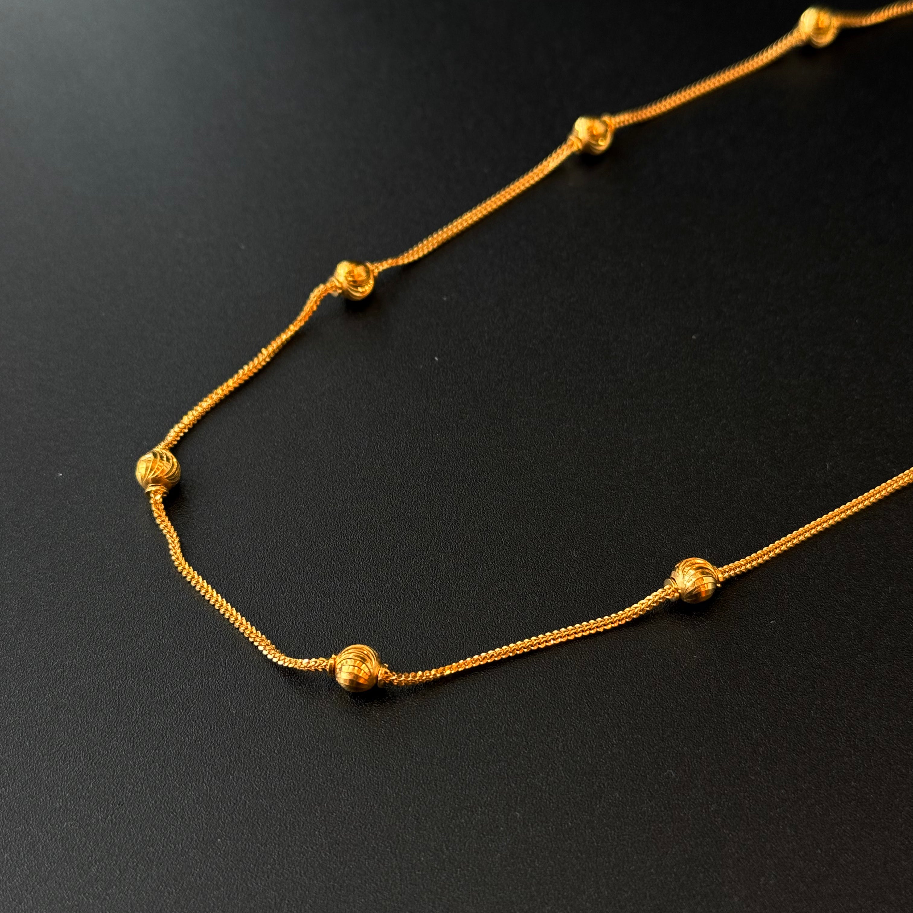 Gold necklace on a black background