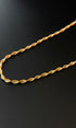 Gold necklace on a black background