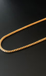 Gold chain on a black background